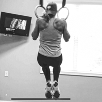 Woman doing a pullup on two rings